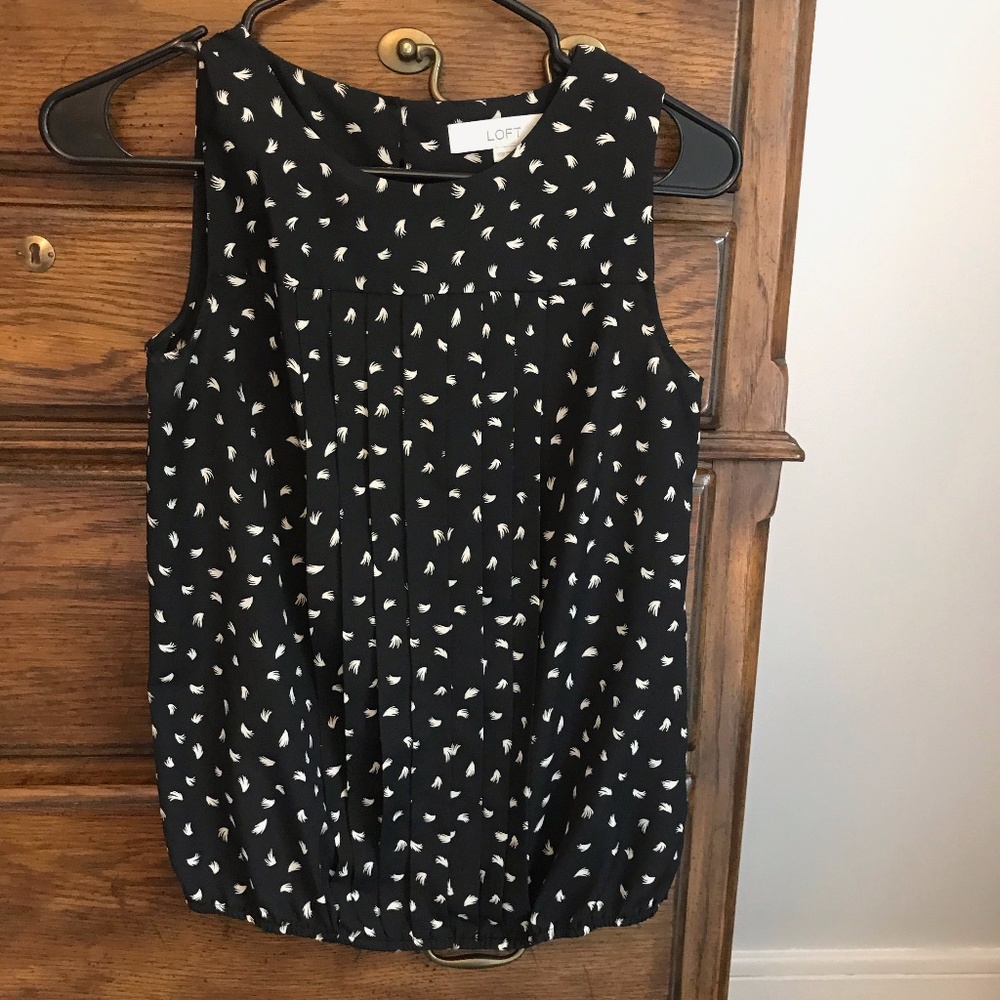 Black and white sleeveless blouse